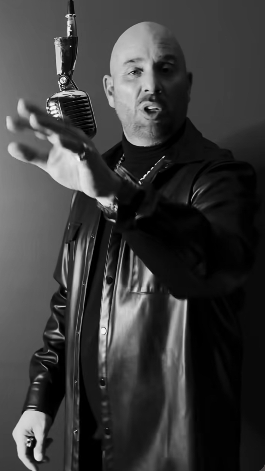 JoJo Pellegrino performing into a vintage chrome microphone