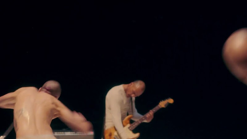 JMSN band member playing sunburst bass guitar on stage
