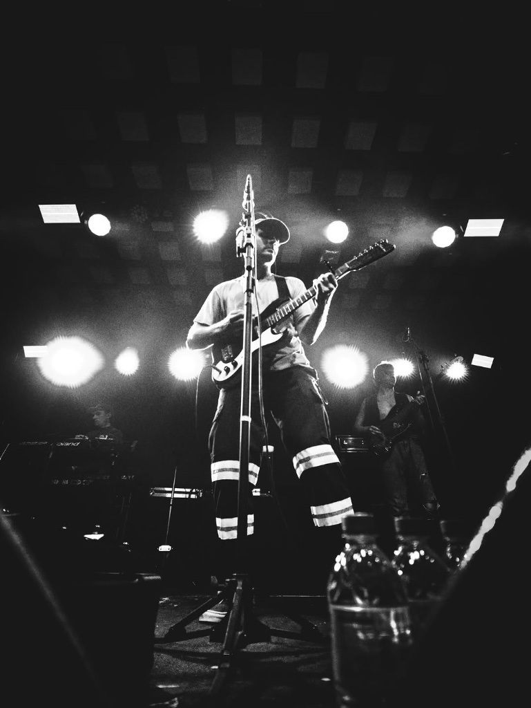 Mac DeMarco live in Brazil — shot from the stage floor, black and white