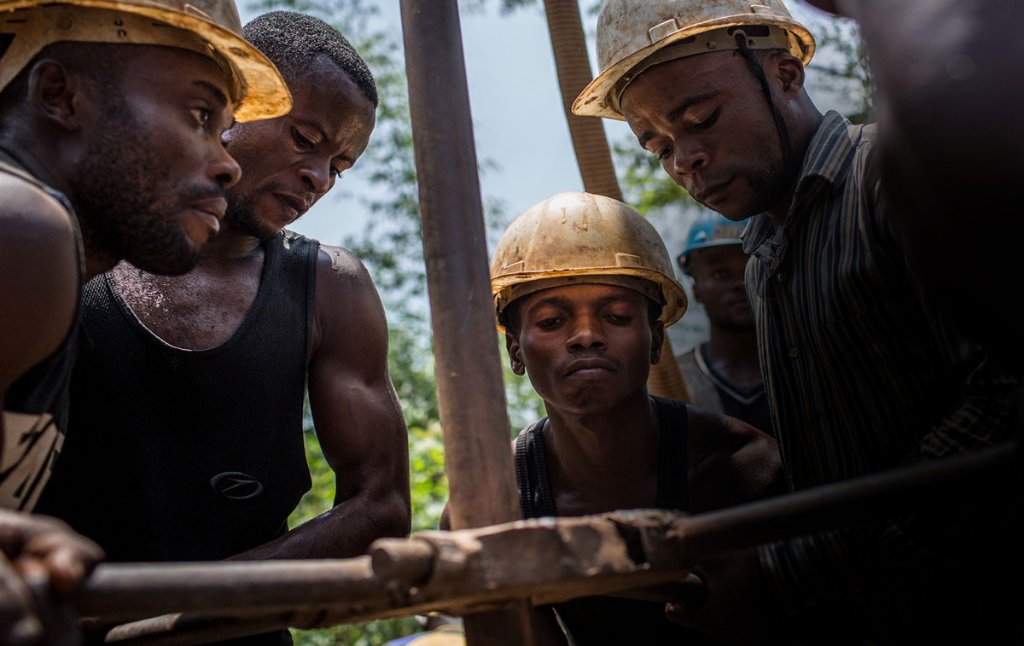 Workers water-jetting at an alluvial gold mining site