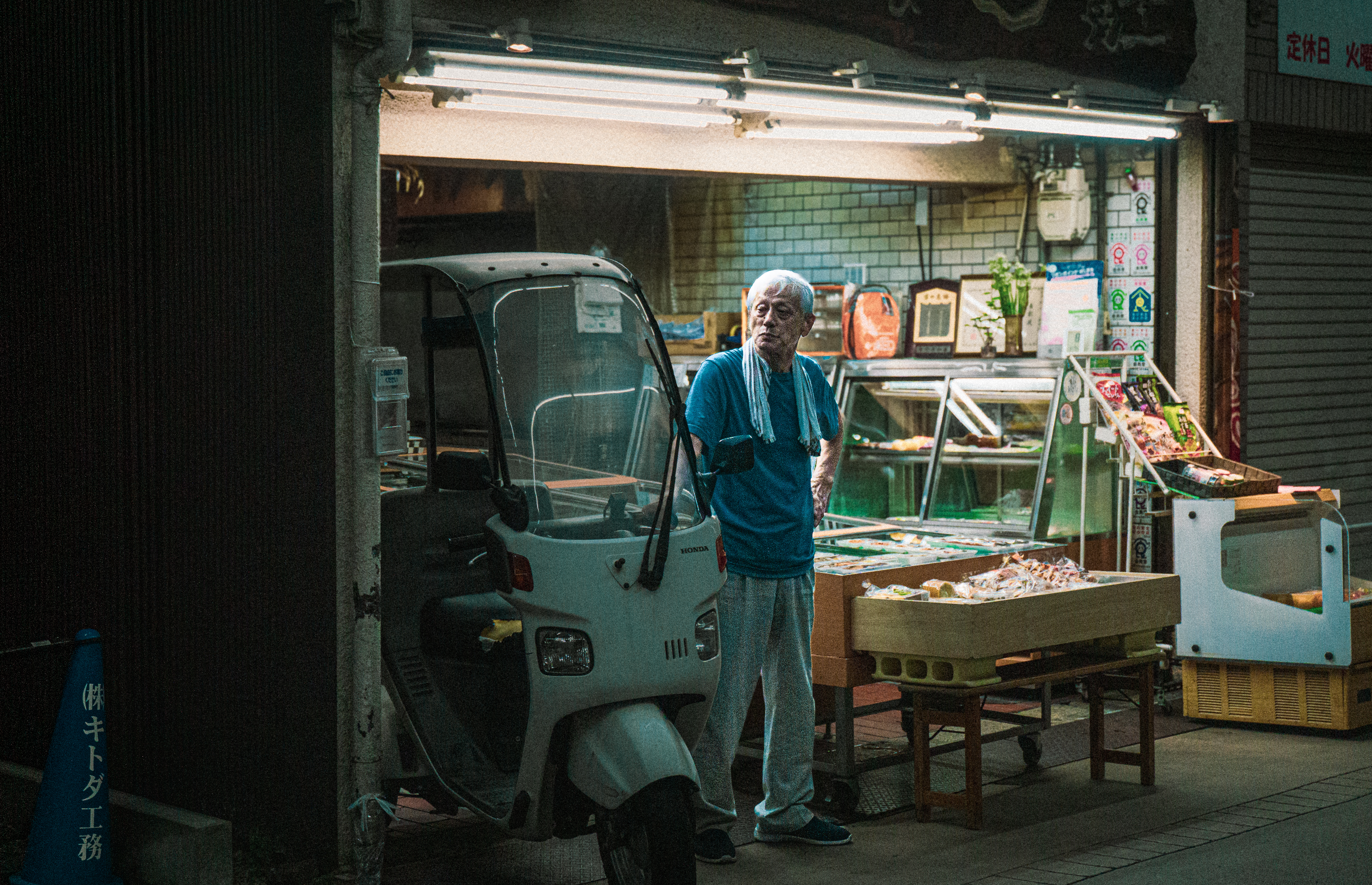 The Stranger | Japan — shopkeeper at night, street photography series by Matteo Jana