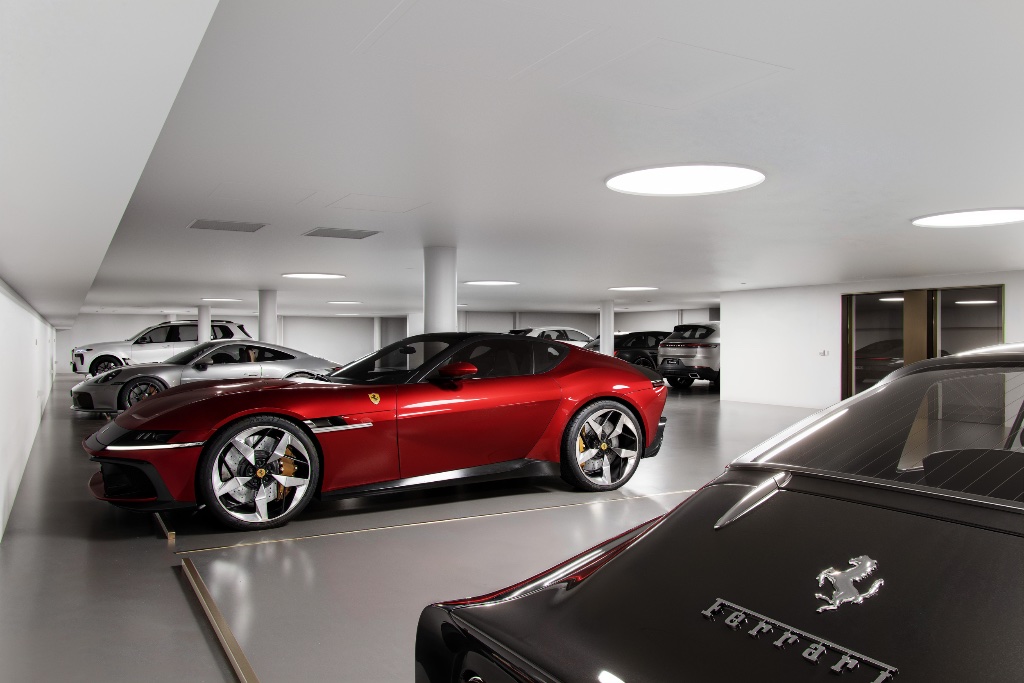 Executive garage with feature lighting and luxury vehicles