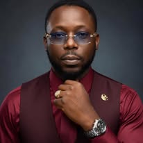 M.J. Evans — Studio Portrait (Maroon Shirt & Vest)