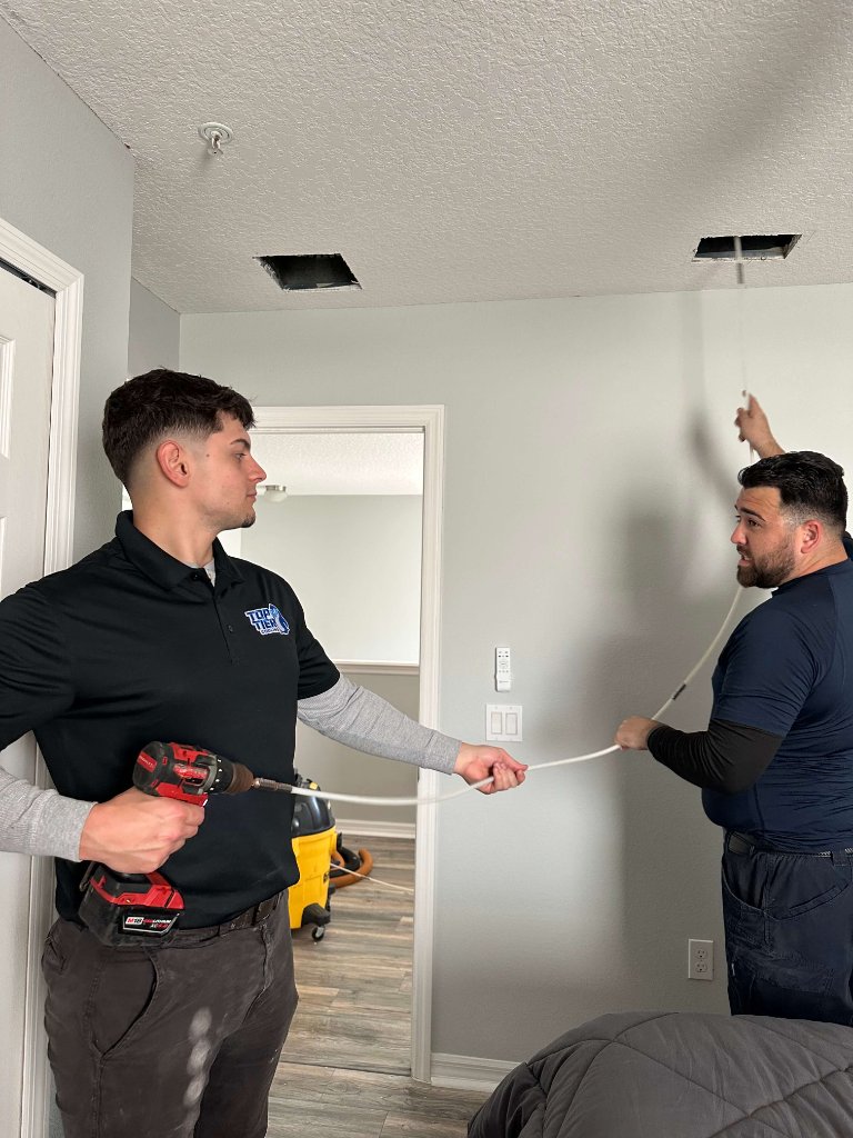 Top Tier Cooling technicians performing air duct cleaning in Orlando FL