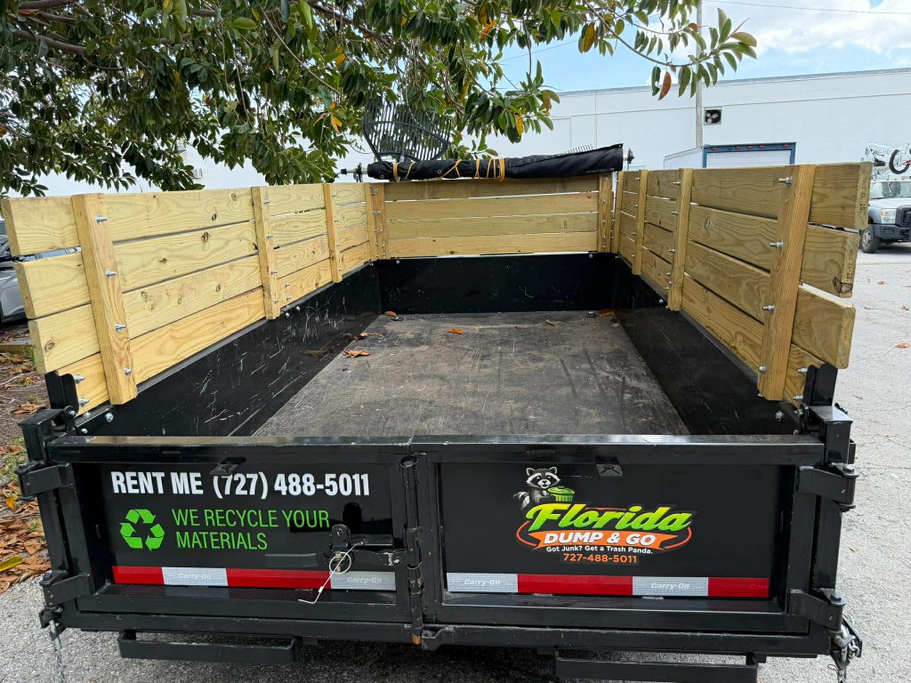 Hydraulic dump trailer loaded with junk removal debris Clearwater Florida