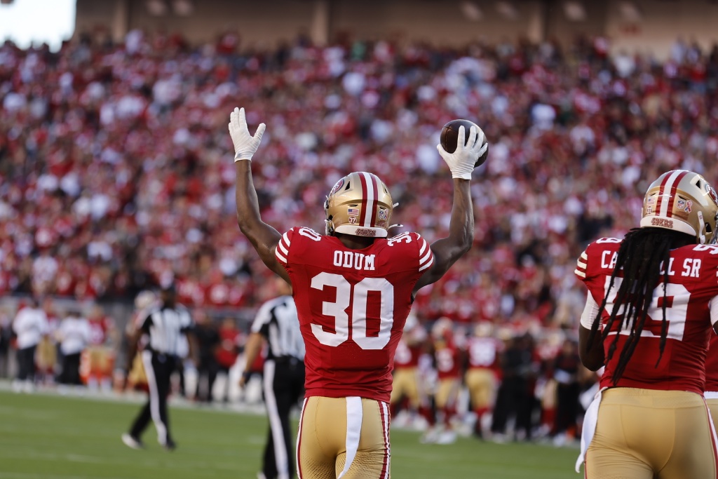 George Odum #30 ODUM celebrates holding the ball high — All-Pro moment
