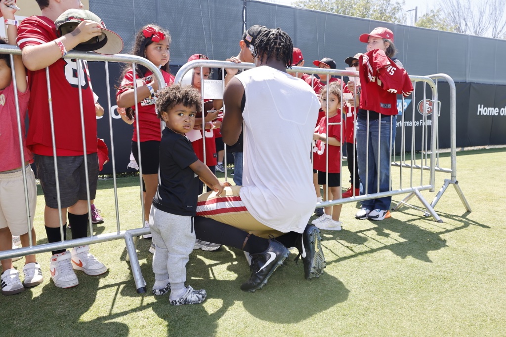 George Odum signing autographs with his son