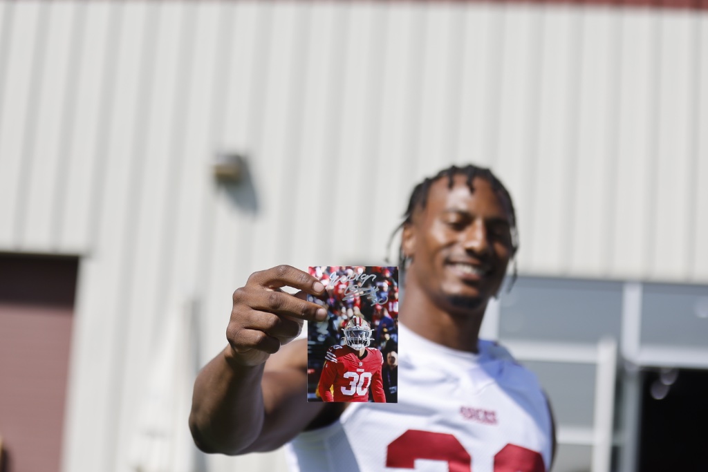 George Odum holding up his autographed photo
