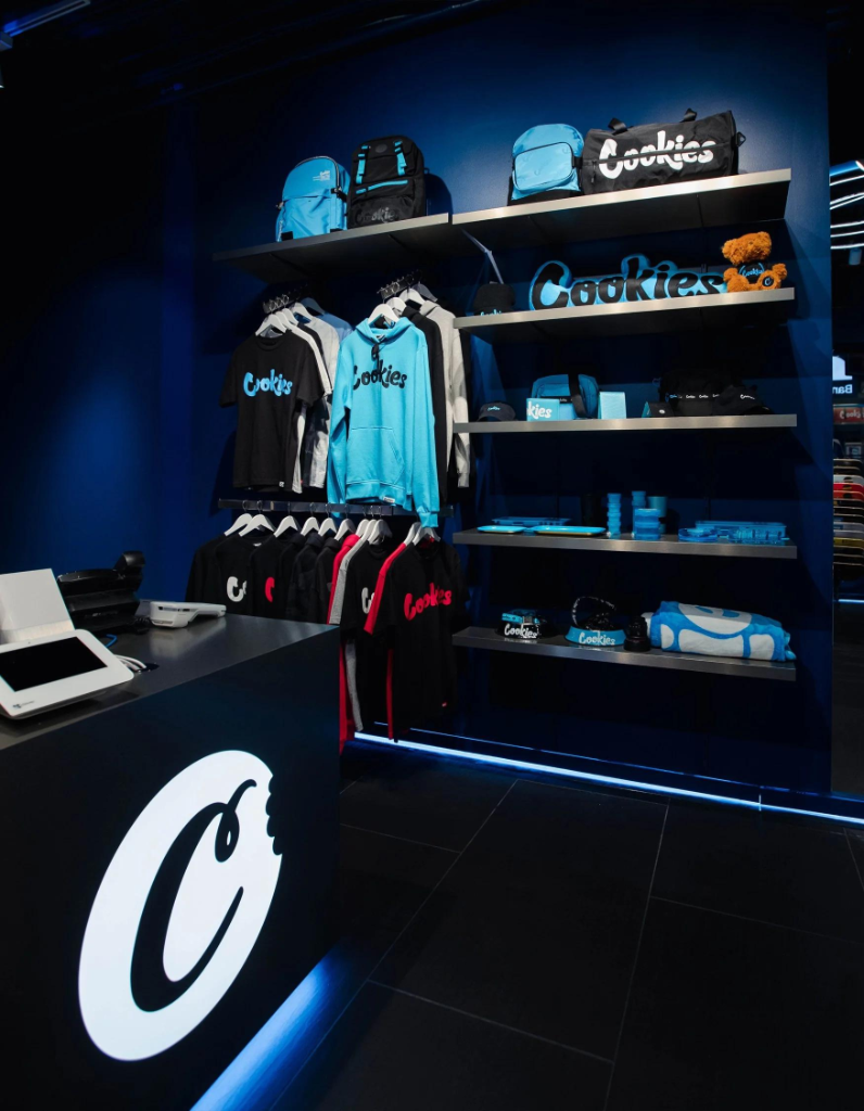 Inside a Cookies retail store — checkout counter and merchandise wall