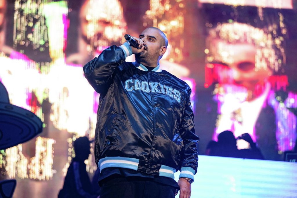 Berner performing on stage in his signature Cookies varsity jacket