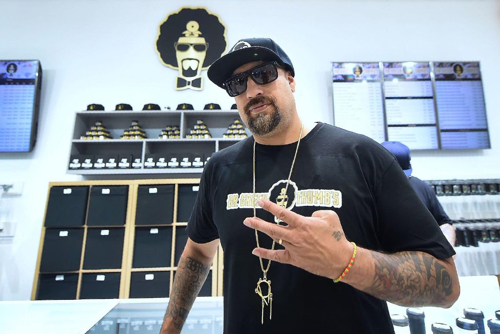 Inside a Dr. Greenthumb's dispensary: branded shelving, digital menu boards, and merchandise display