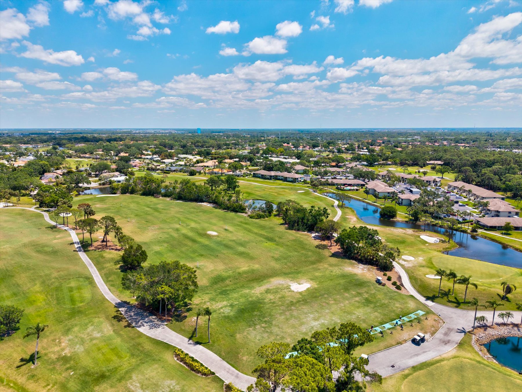 Fairways, ponds, and homes threaded through the canopy