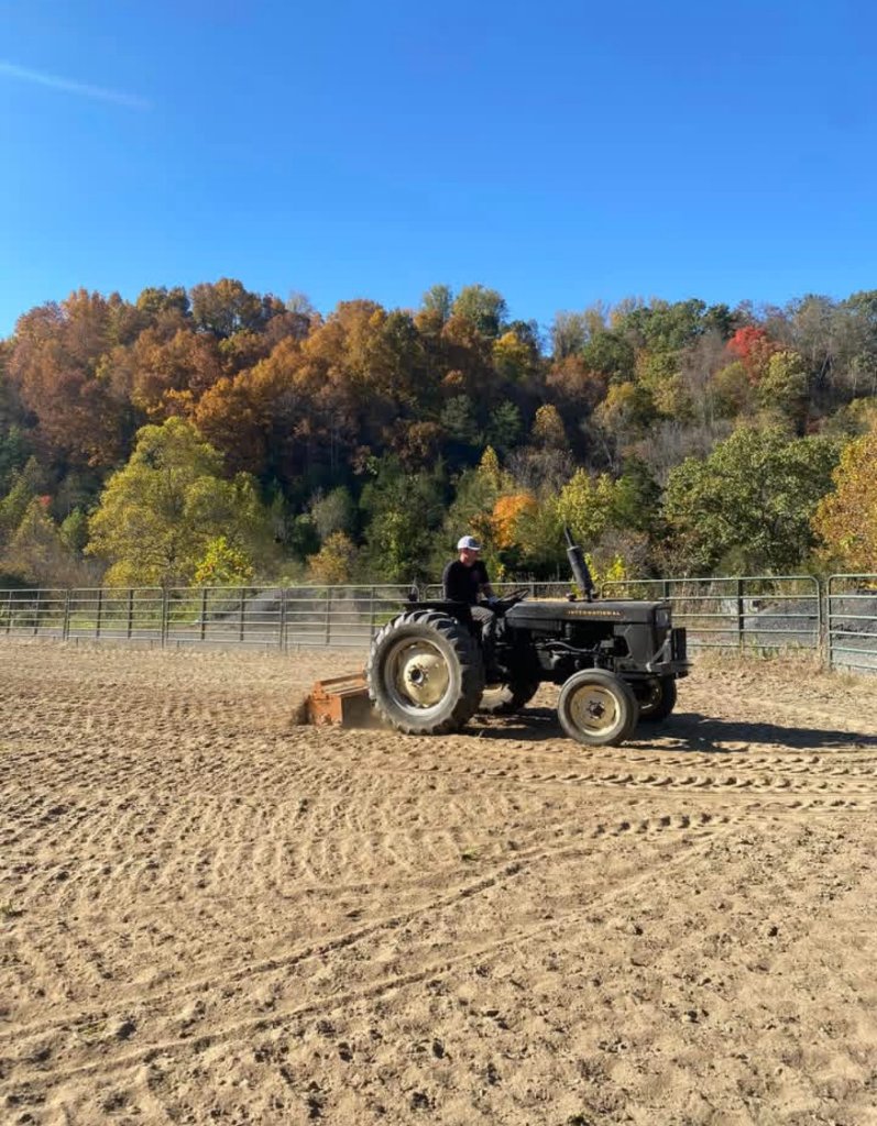Tractor grooming arena in fall