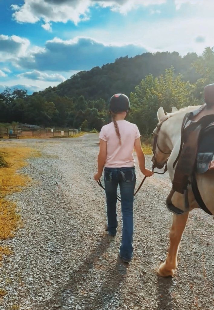 Girl walking with horse at Little Patch of Heaven