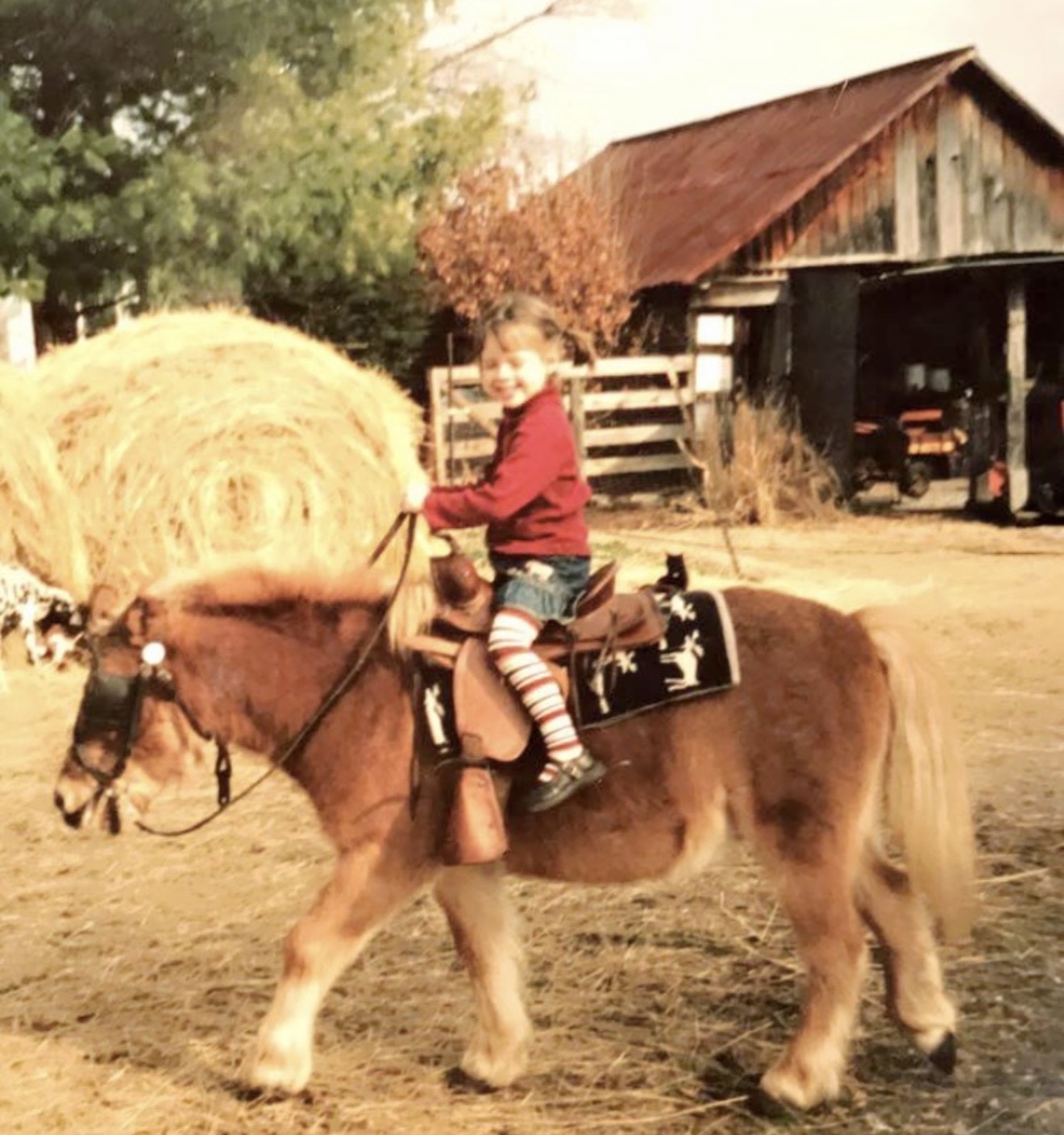 A young Moriah riding a pony