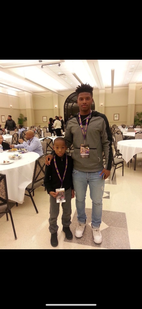 Young Karmelo Anthony dressed up at formal event with lanyards