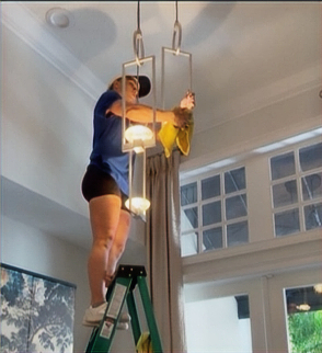 Team cleaning chandelier