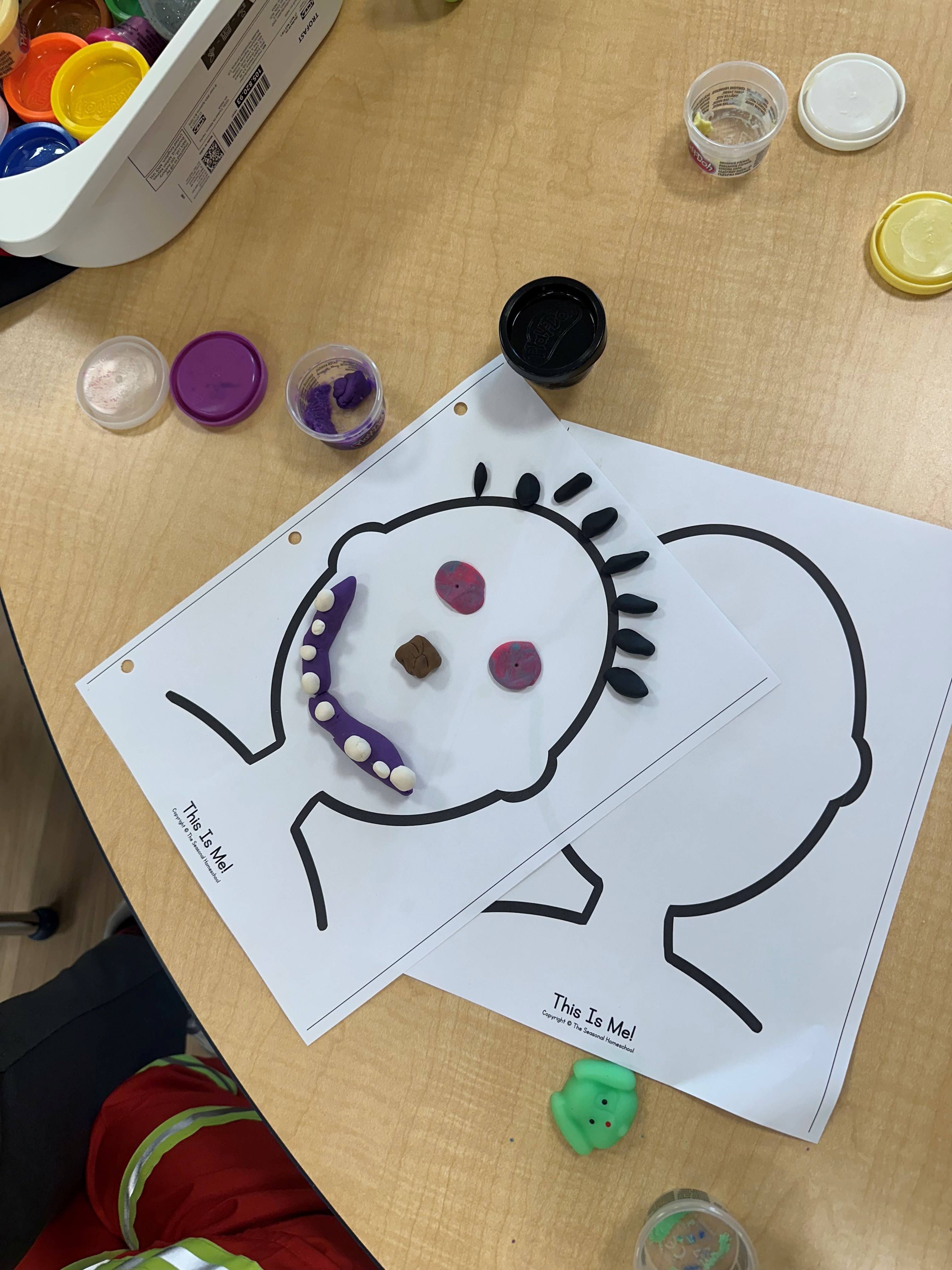 A child's clay self-portrait art activity at Sunny Days.