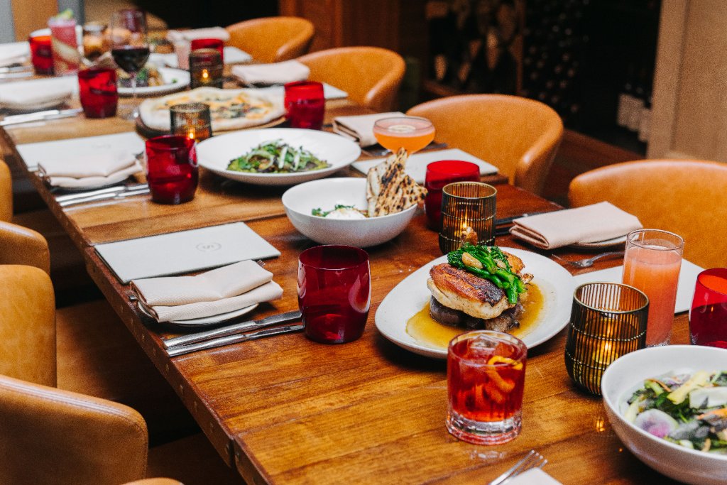 Society Cafe dining table with plated dishes and cocktails