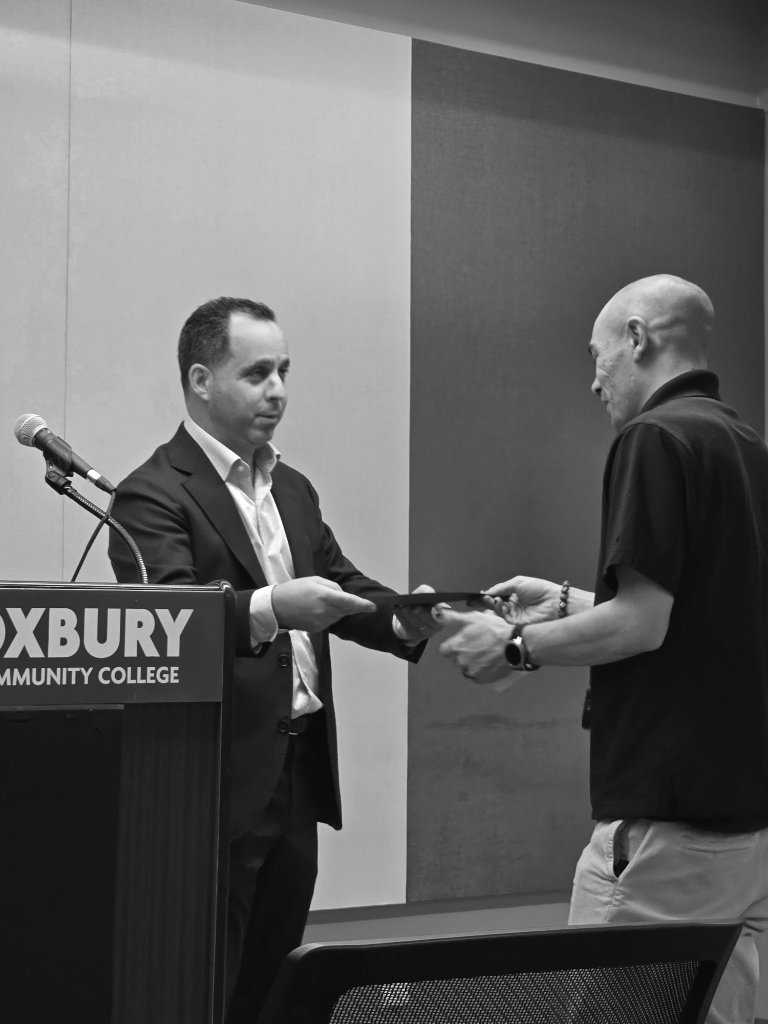 Adam C. Connell receiving diploma at Roxbury Community College