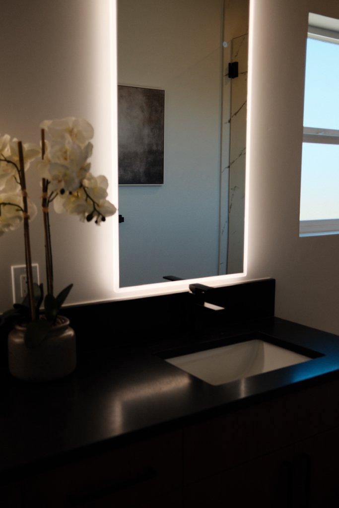 Powder Bath — Backlit Mirror & Black Countertop