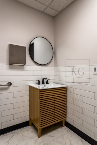 Secondary restroom — warm wood vanity