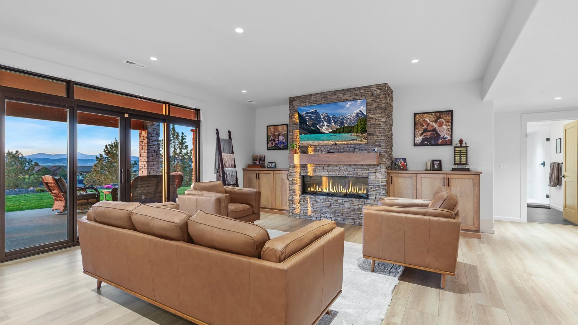 Living Room — Stone Fireplace & Leather Seating