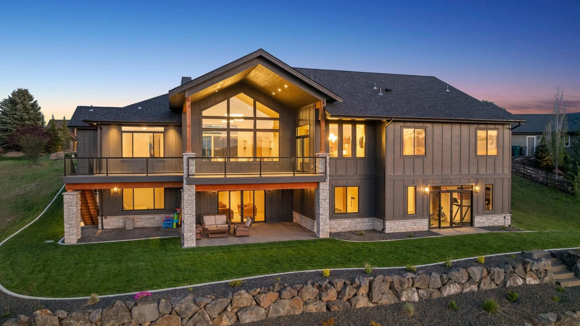 Exterior Rear — Upper Deck & Covered Patio at Dusk