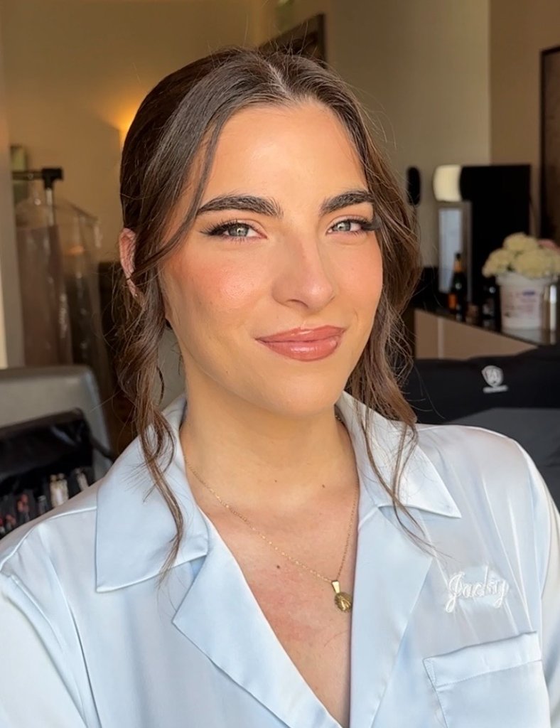 Tan girl with gold accessories smiling
