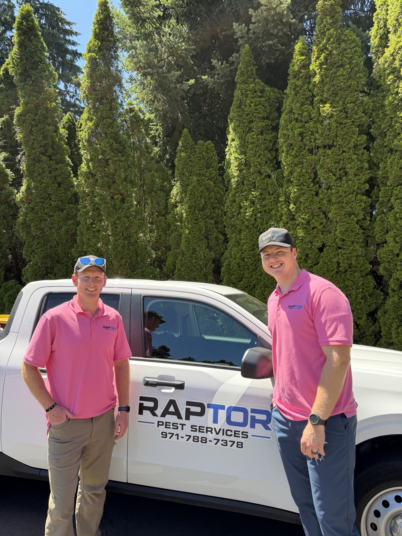 Raptor Pest Services team in front of a branded service truck in the Portland metro area