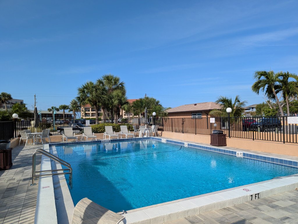 Community heated pool with lounge chairs