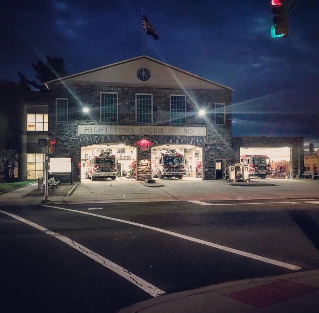 Volunteer firefighters walking out of the station at golden hour