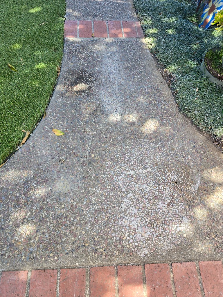 Old worn exposed-aggregate concrete patio before epoxy resurfacing by Epoxy Renovations