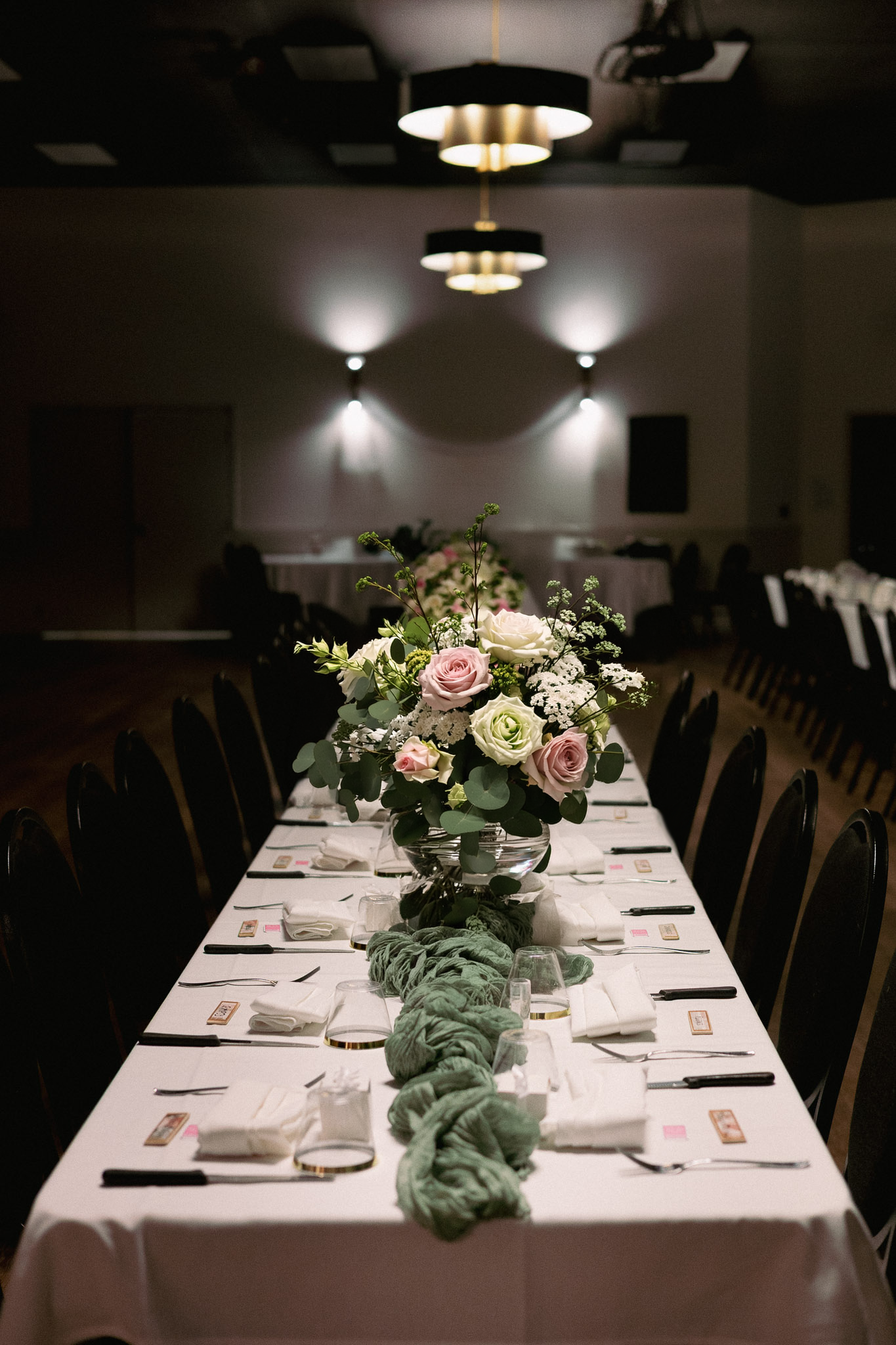 Close-up of a wedding reception table setting with floral centerpiece