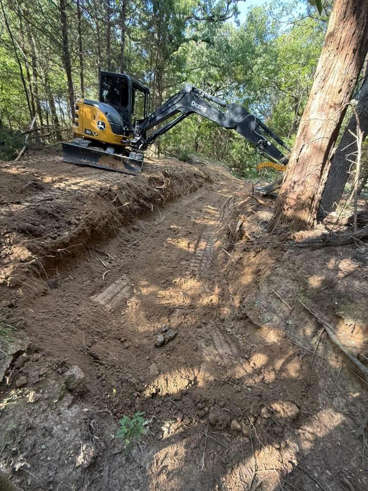 Excavation contractor grading property for drainage and site preparation in Texas