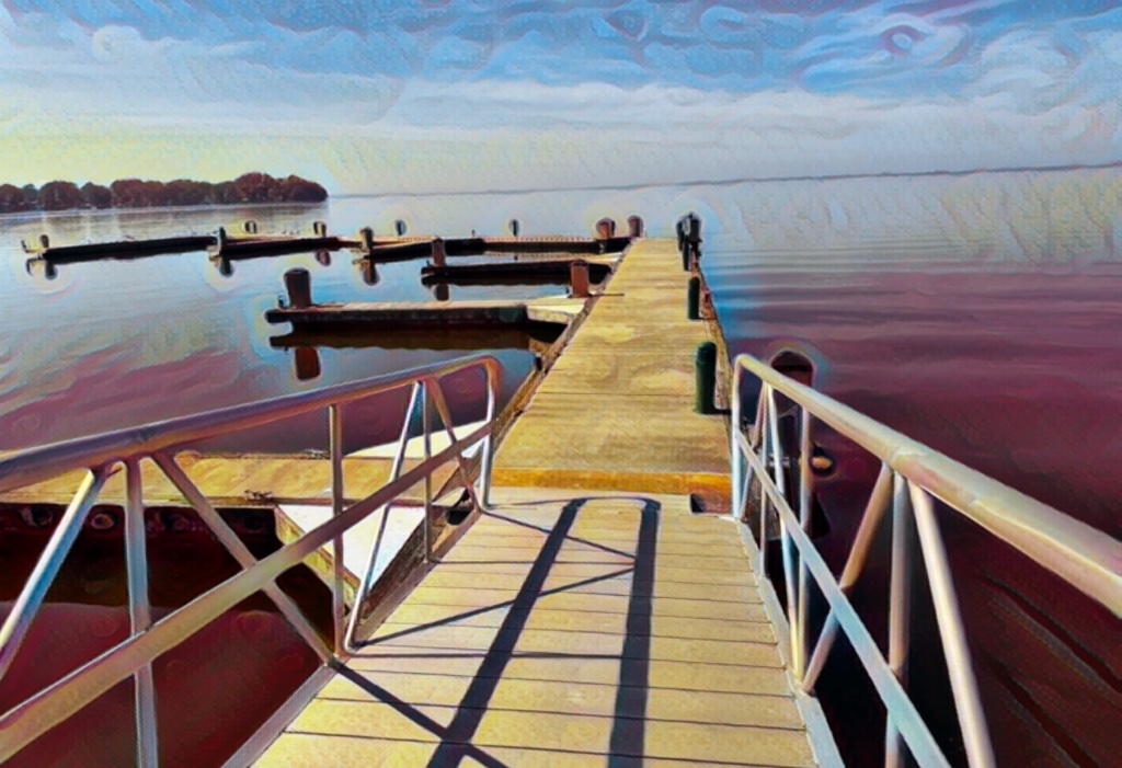 A sunlit dock stretching out over calm water