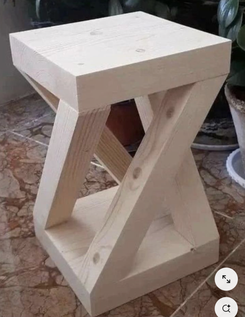 Twisted Leg Stool — a sculptural pine side stool with legs joined at opposing angles