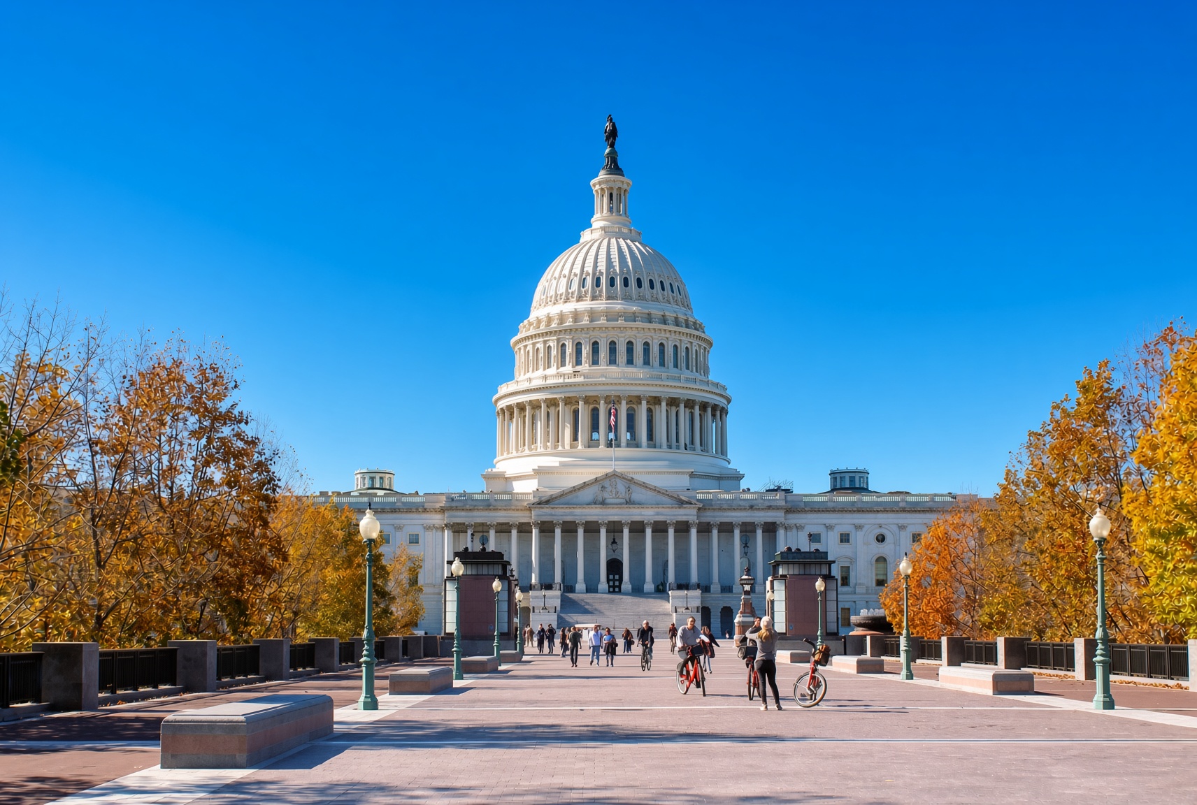The US Capitol building on a crisp autumn day with golden trees lining the approach