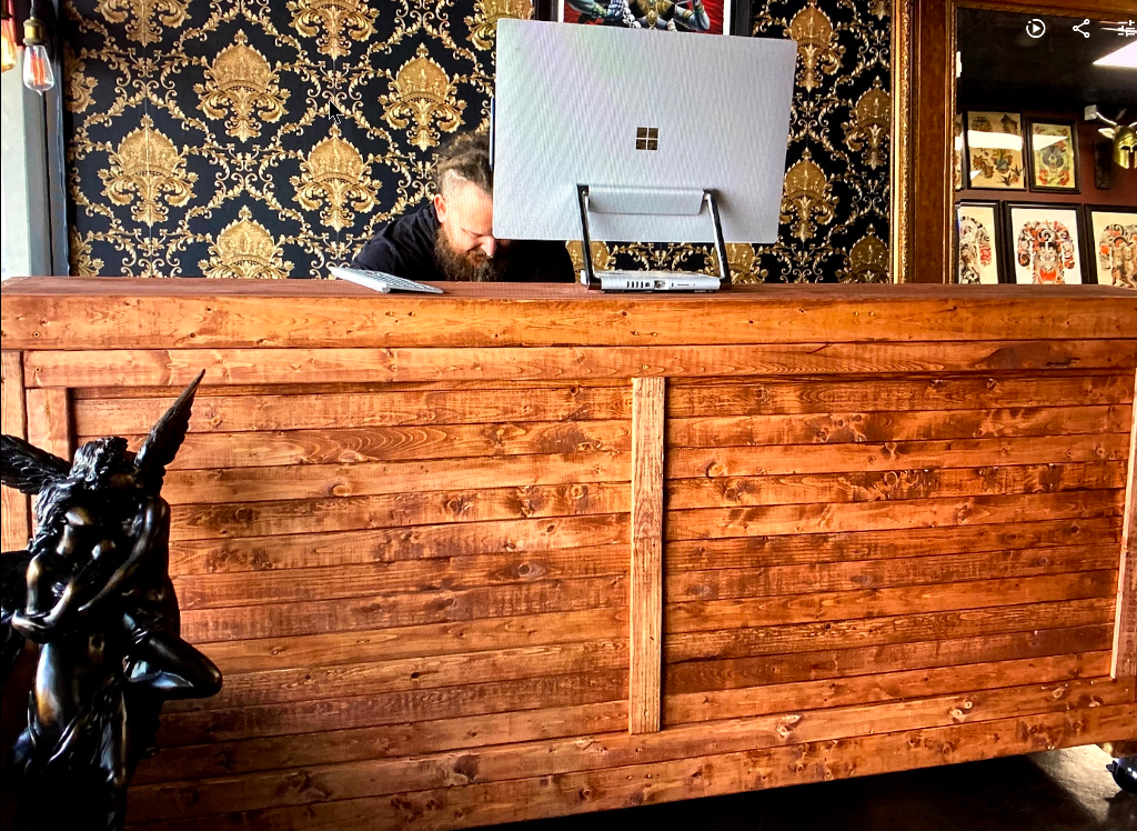 Reception Desk — a reclaimed pine slat-front desk built for a shop counter