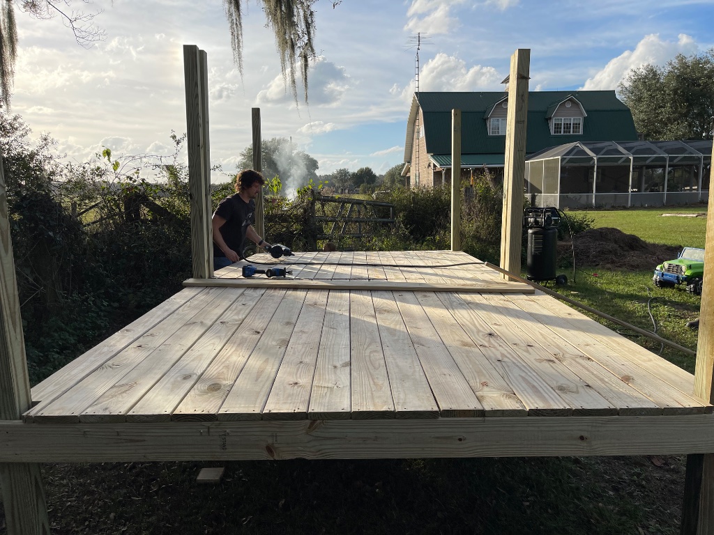 Backyard Deck — a frame-and-board deck built post by post overlooking the farm