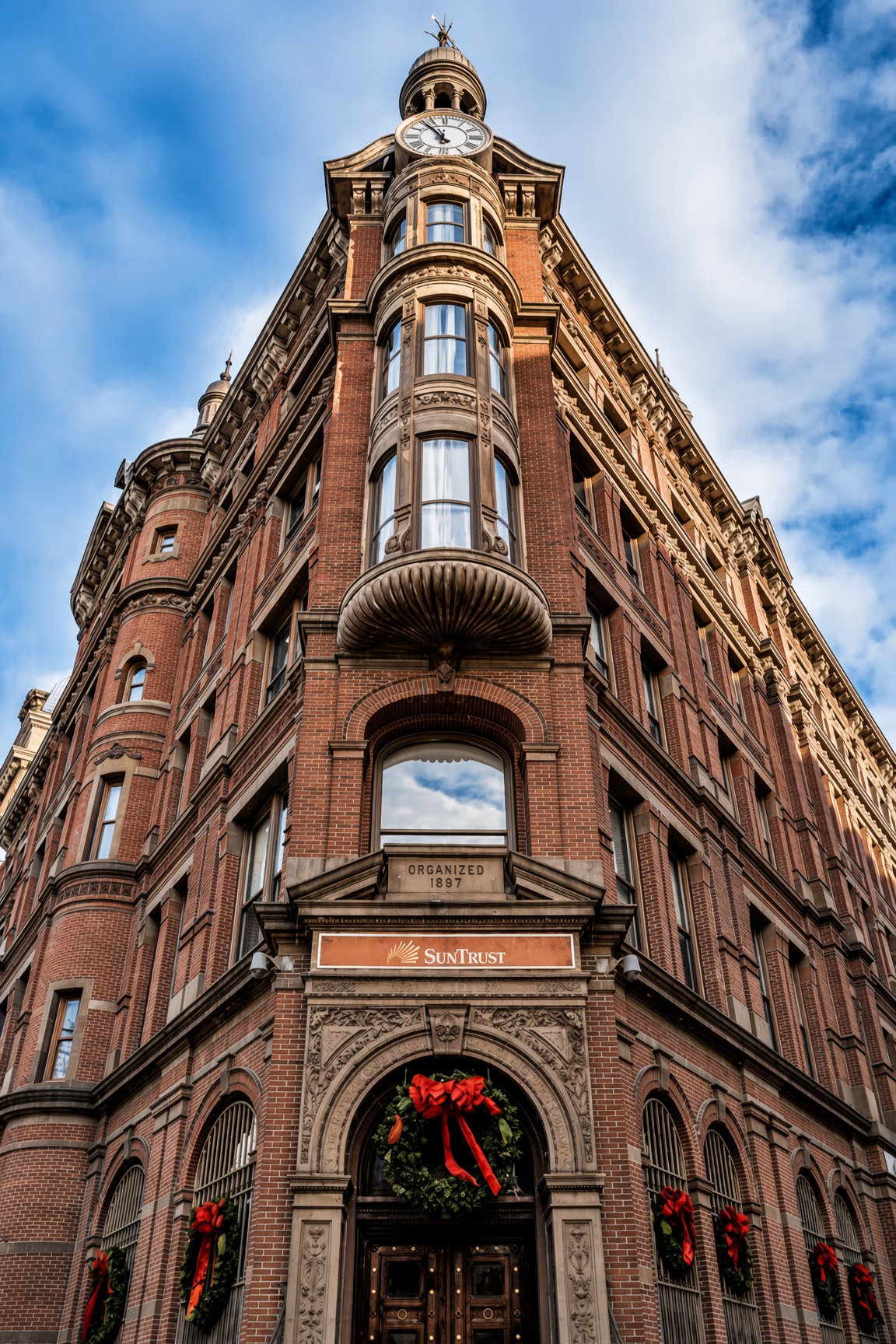 The historic SunTrust/Flatiron building in Washington DC at dusk with Christmas wreaths