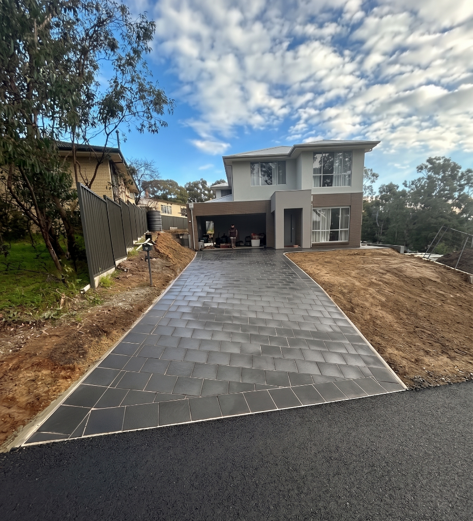 Driveway — charcoal pavers with clean edge restraint