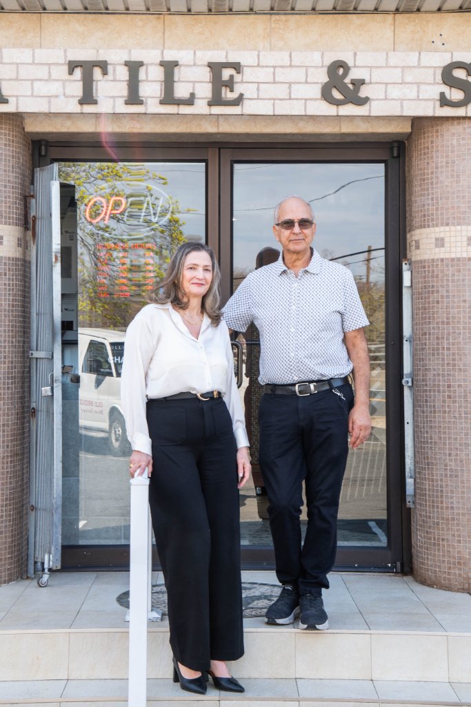 Owners of Decora Tile and Stone inside their showroom with tile and stone displays