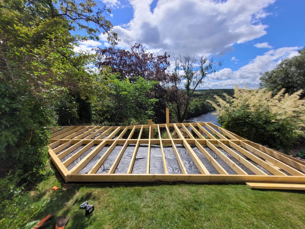 Screw pile foundation system with BaseShield sub-base defense installed before deck construction