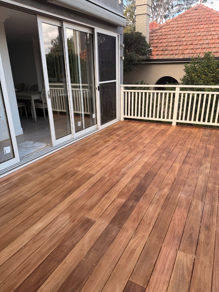 Blackbutt timber deck with white balustrade and sliding doors from side angle