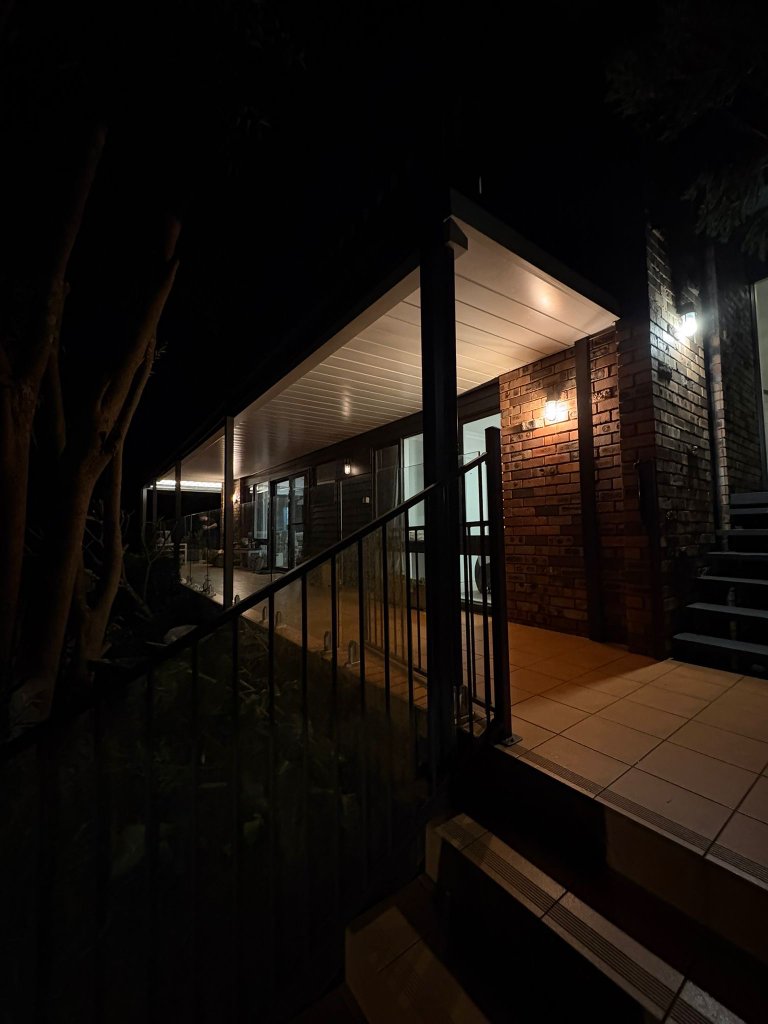 Raised deck and covered pergola at night with outdoor lighting Sydney