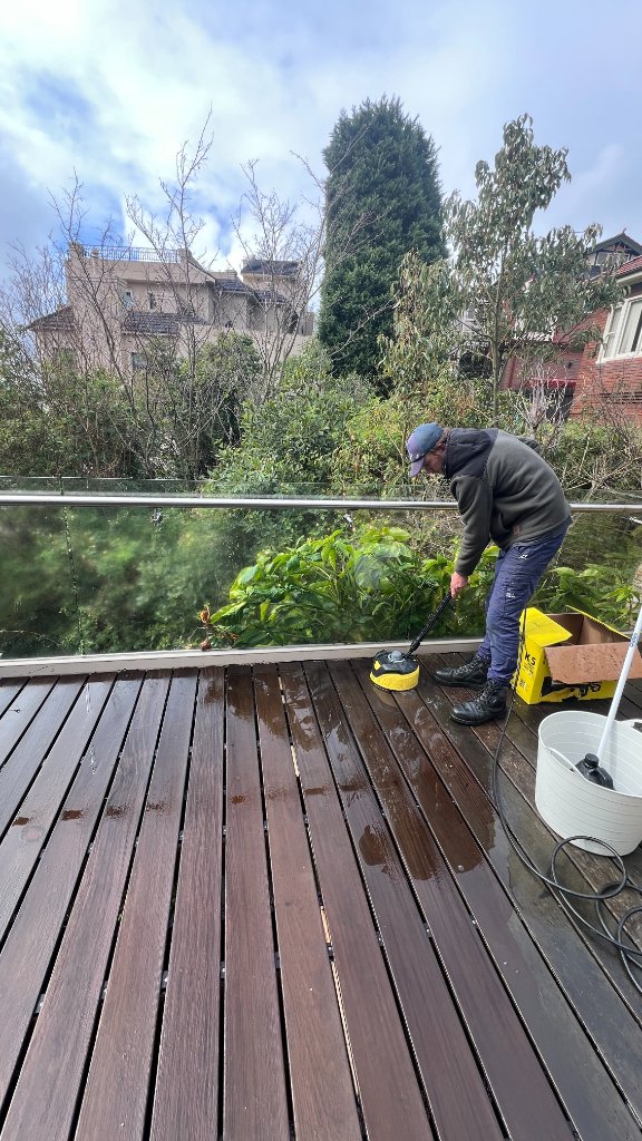 Pressure cleaning hardwood deck with glass balustrade Sydney