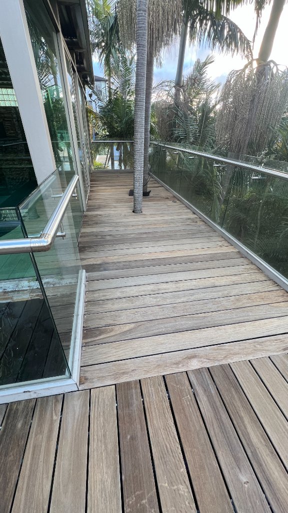 Merbau deck mid-restoration sanding Earlwood - boards opening up