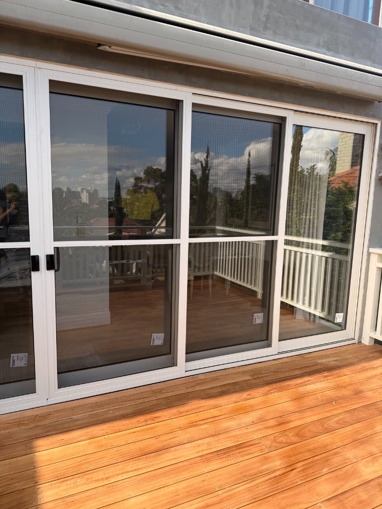 New sliding stacker doors opening onto freshly laid Blackbutt timber deck