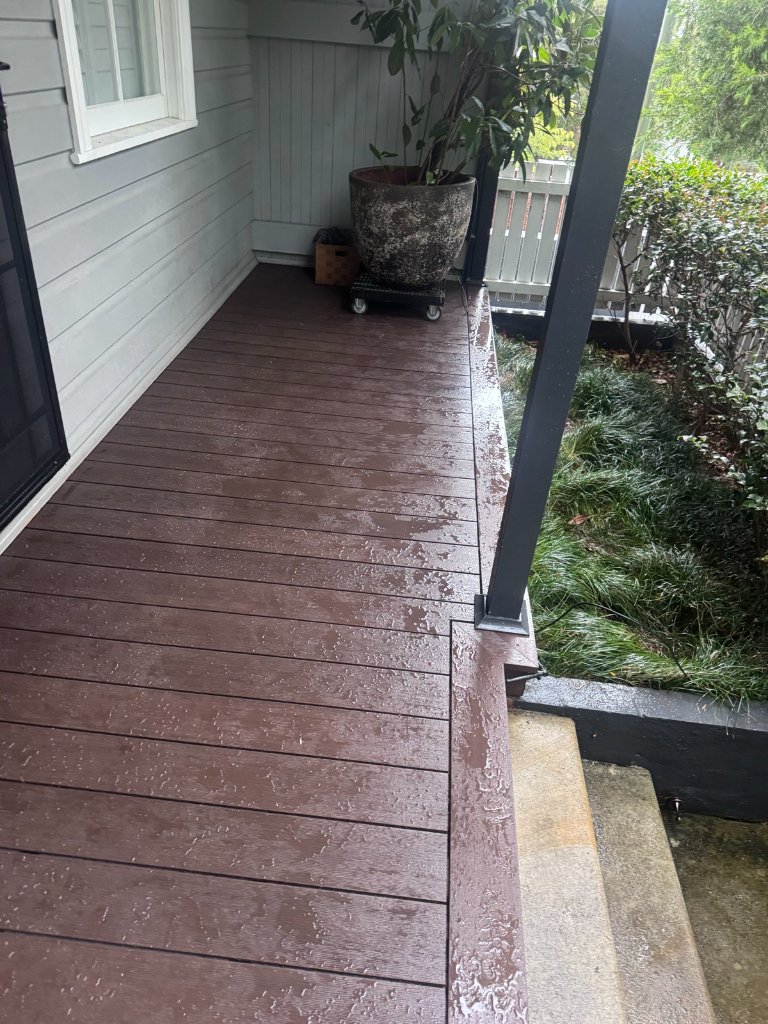Full length WPC composite deck running side of Sydney home with black steel frame